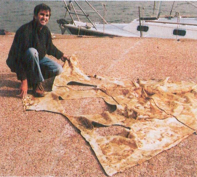 Photo of a person removing the ceiling from a cabin with crumbled foam